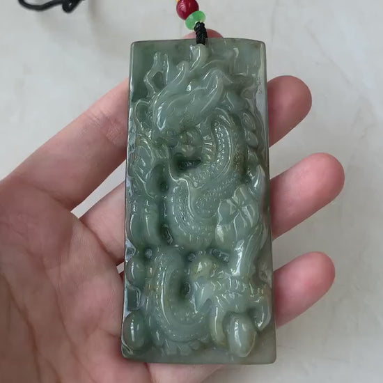 Video of a hand-carved natural jadeite jade dragon pendant in rich green with detailed scales and claws