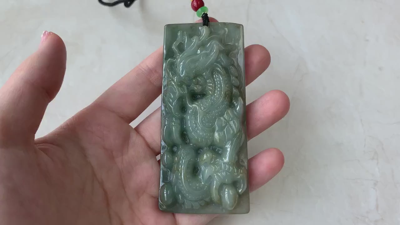 Video of a hand-carved natural jadeite jade dragon pendant in rich green with detailed scales and claws