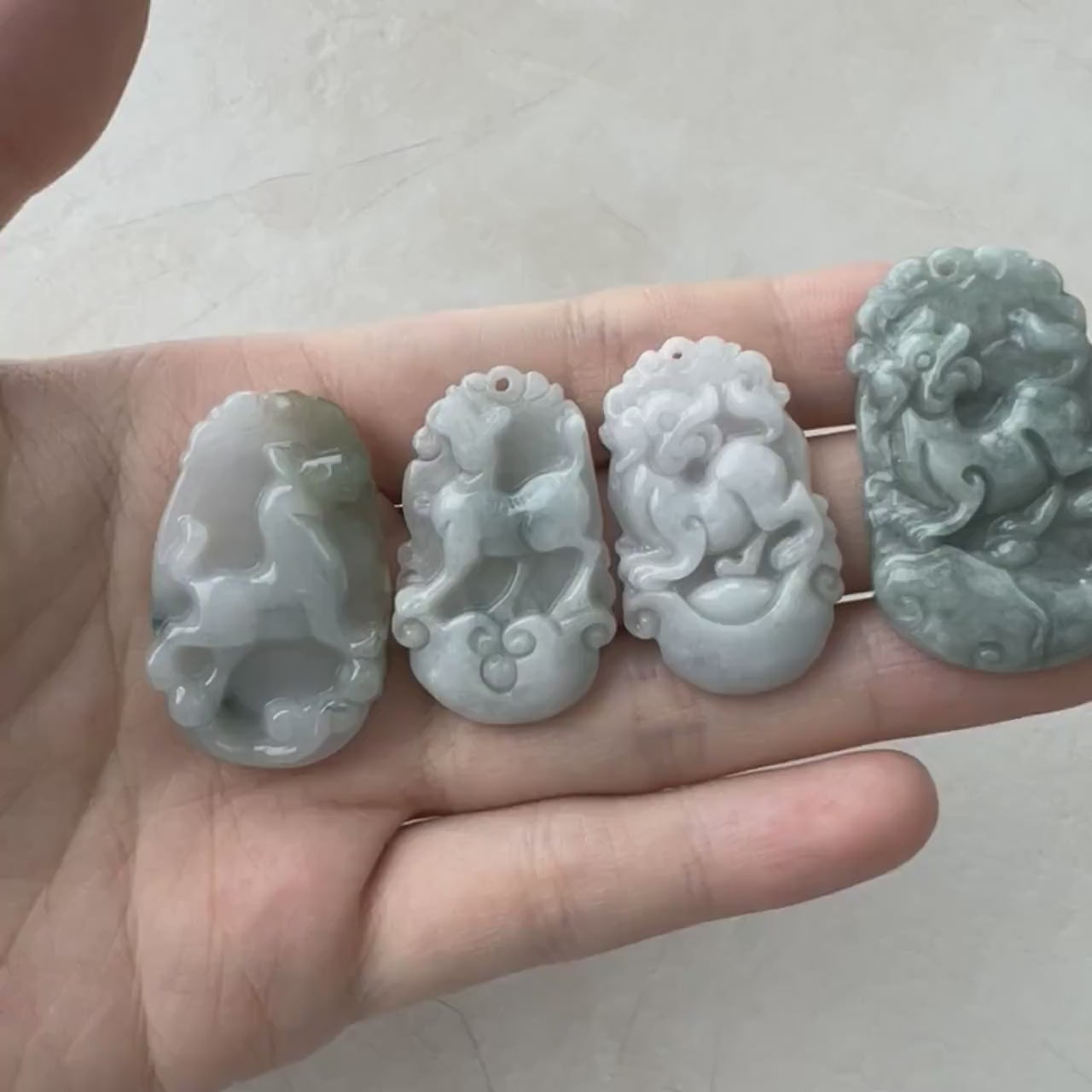 Video of hand-carved natural jadeite Dog Zodiac pendant in unique multicolor translucent jade with organic texture