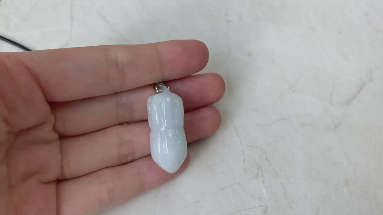 Video of a hand-carved white jade peanut pendant with subtle green-gray tones on an 18-inch faux leather necklace