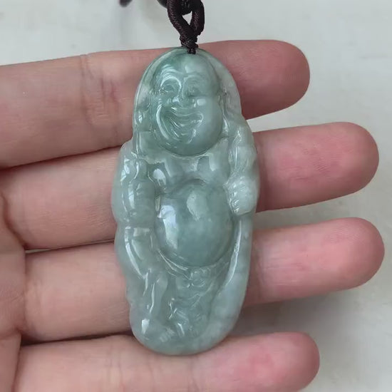 Video of a hand-carved green jade Laughing Buddha pendant with smooth, detailed traditional carving and joyful expression