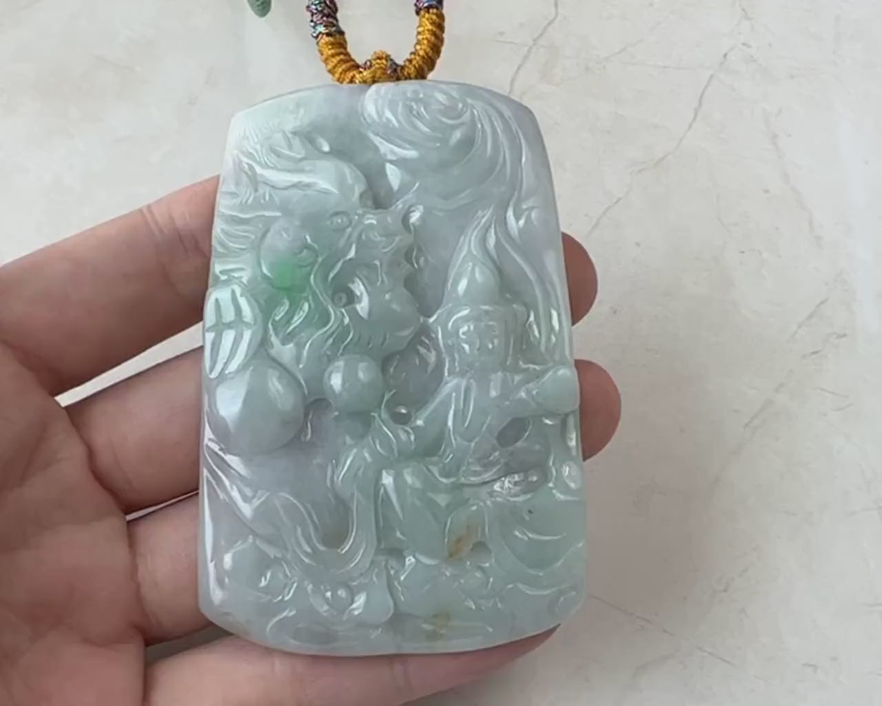 Video of hand-carved green jadeite pendant with bodhisattva and dragon motif, one-of-a-kind spiritual style