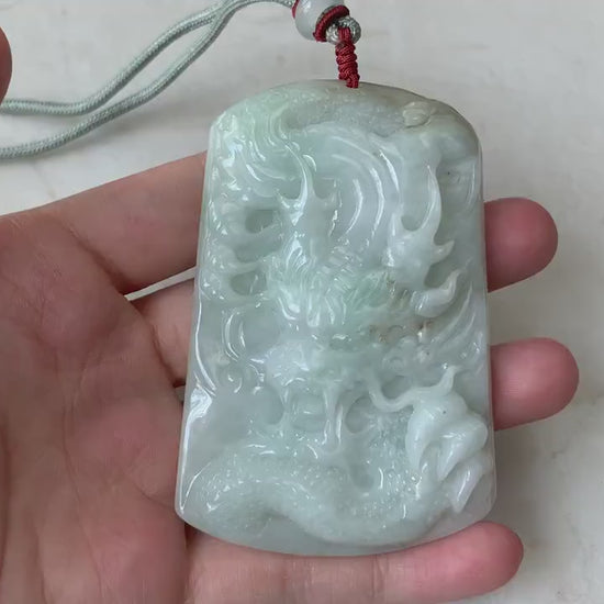 Video of a large light green jadeite pendant with a detailed hand-carved Chinese dragon design