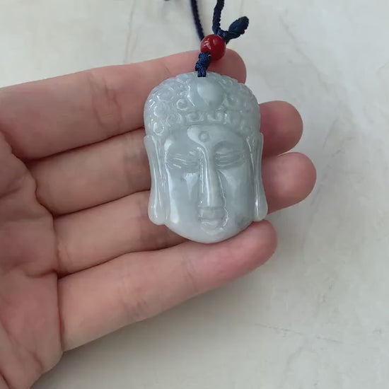 Video of a hand-carved natural jadeite jade Buddha head pendant in green with a rare dual-faced design