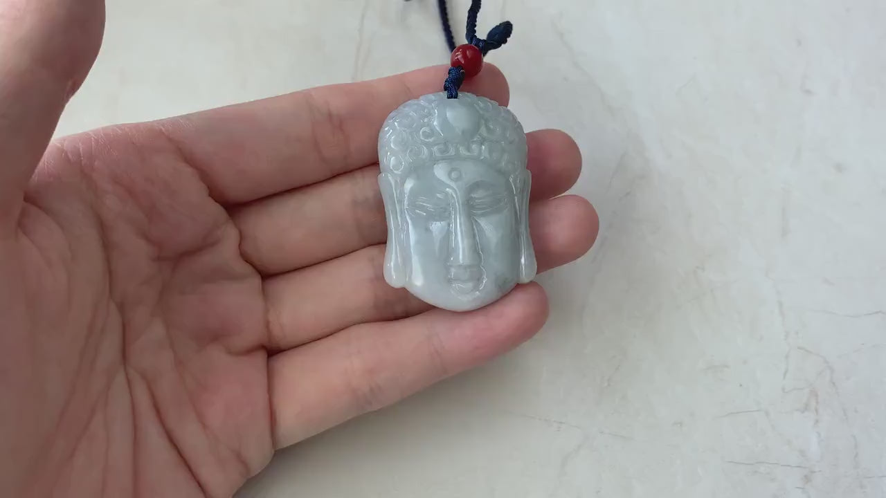 Video of a hand-carved natural jadeite jade Buddha head pendant in green with a rare dual-faced design