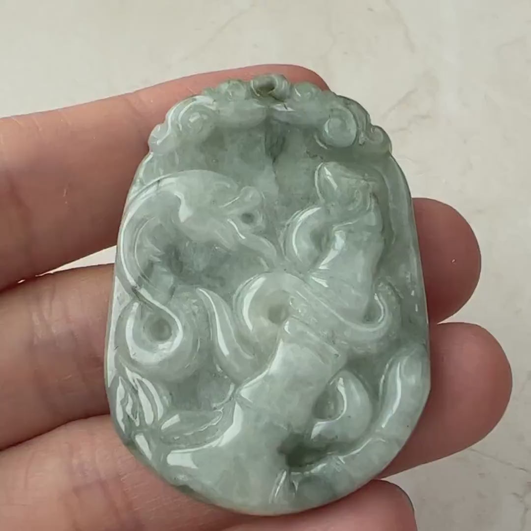 Video of a hand-carved natural jadeite jade pendant in green, featuring a Chinese zodiac snake with bamboo detail.