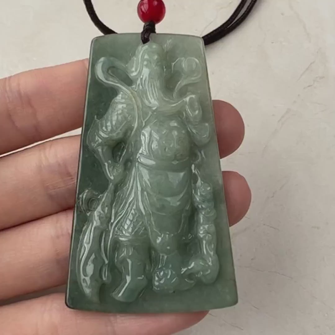 Video of a hand-carved natural jadeite jade Guan Yu pendant in green, symbolizing strength and prosperity