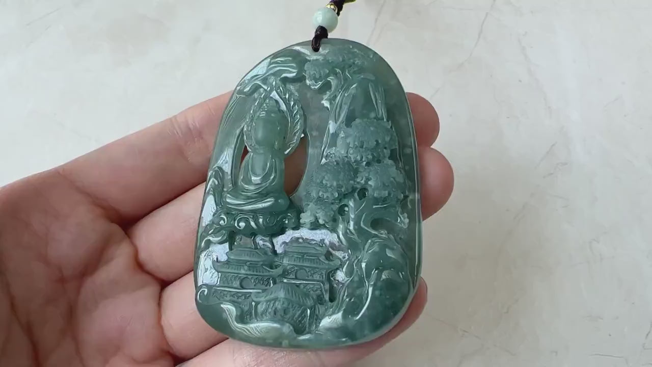Video of a polished deep green carved stone pendant with a faceless Buddha and tranquil mountain relief scene