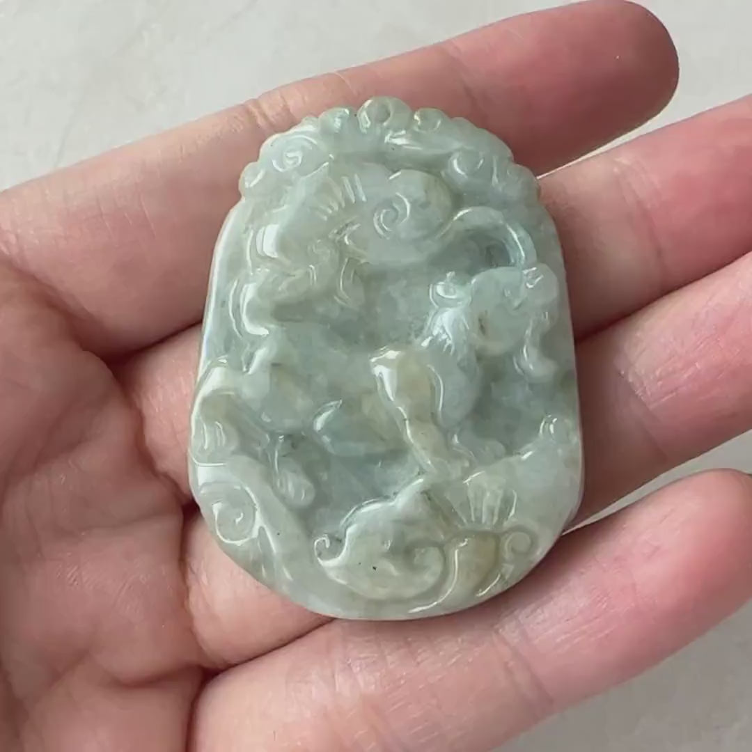 Video of a hand-carved natural jadeite jade Zodiac Rat pendant with Ruyi motifs in green, symbolizing good fortune