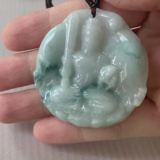 Video of a hand-carved natural jadeite jade pendant featuring Acala Buddha in green with intricate details
