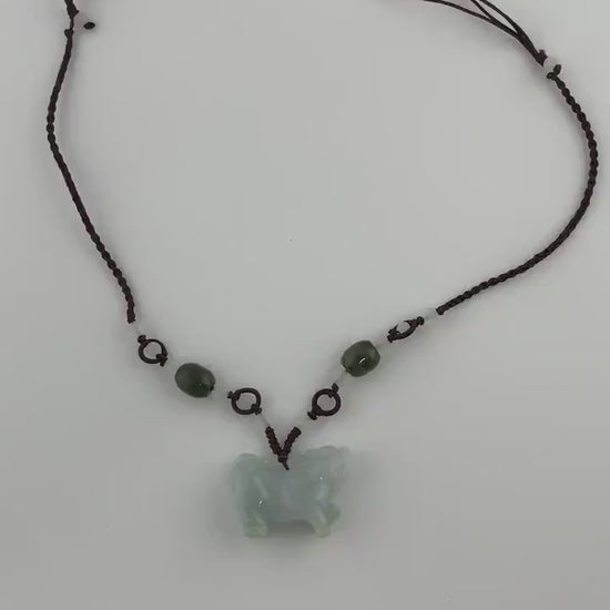 Video of a high-grade natural jade pendant with a 3D hand-carved Qilin, green, intricate and mythical style
