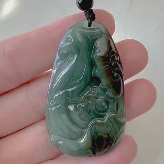 Video of a hand-carved pendant with a graceful bird and delicate floral motifs, detailed and elegant in style