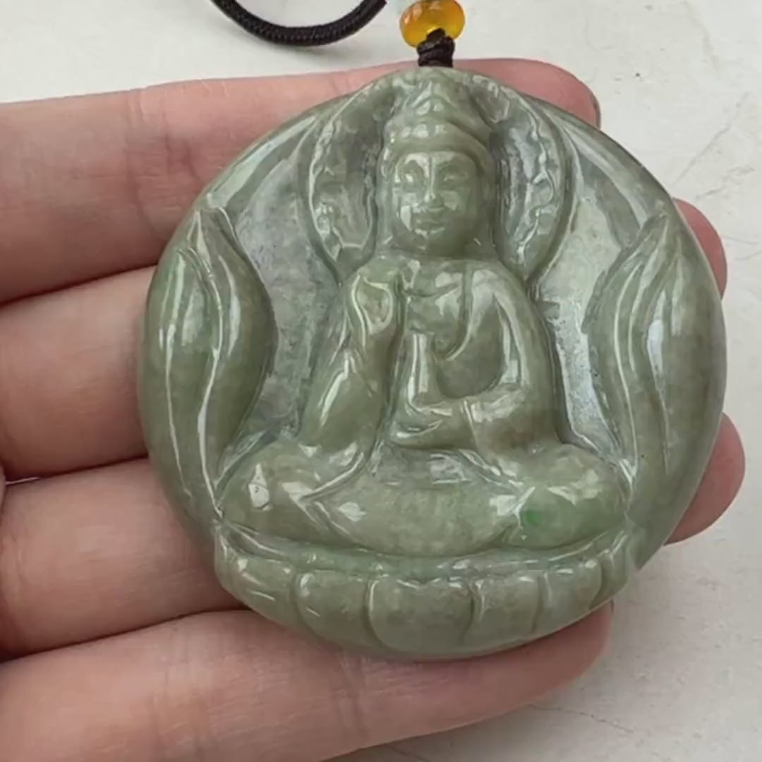 Video of a hand-carved green jade Guan Yin pendant with a serene, spiritual, one-of-a-kind design