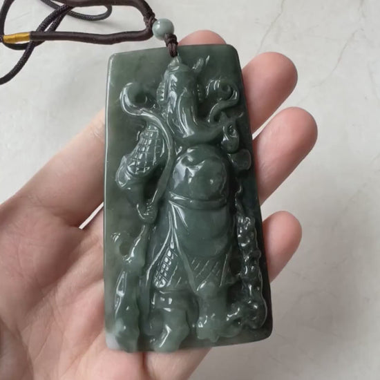 Video of a hand-carved green jadeite jade Guan Gong pendant with detailed, traditional craftsmanship