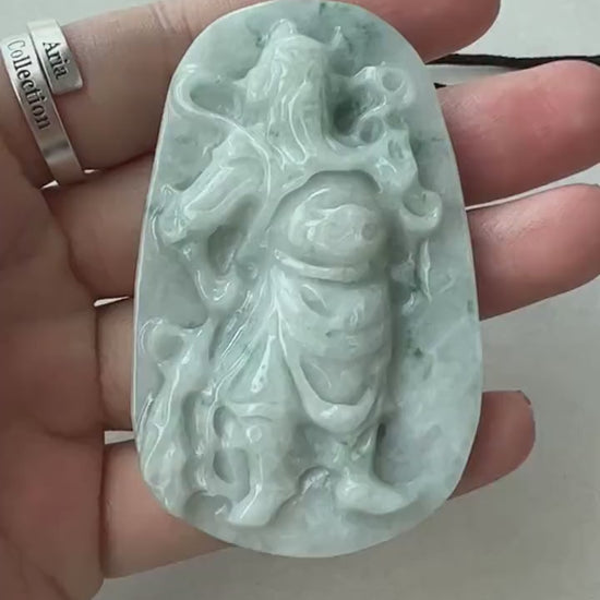 Video of hand-carved natural jadeite jade pendant with Guan Yu relief and abstract mountain landscape, green traditional styl