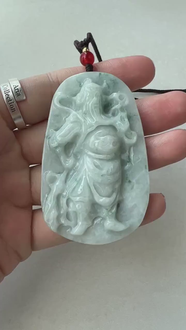 Video of hand-carved natural jadeite jade pendant with Guan Yu relief and abstract mountain landscape, green traditional styl