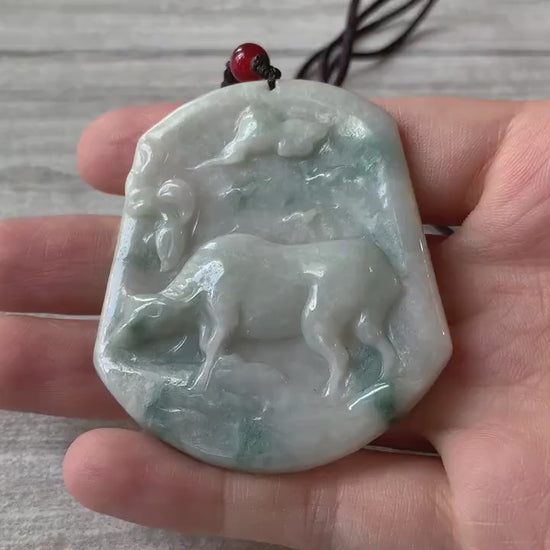 Video of a hand-carved jade ox pendant with detailed muscles, showcasing a green symbolic zodiac design