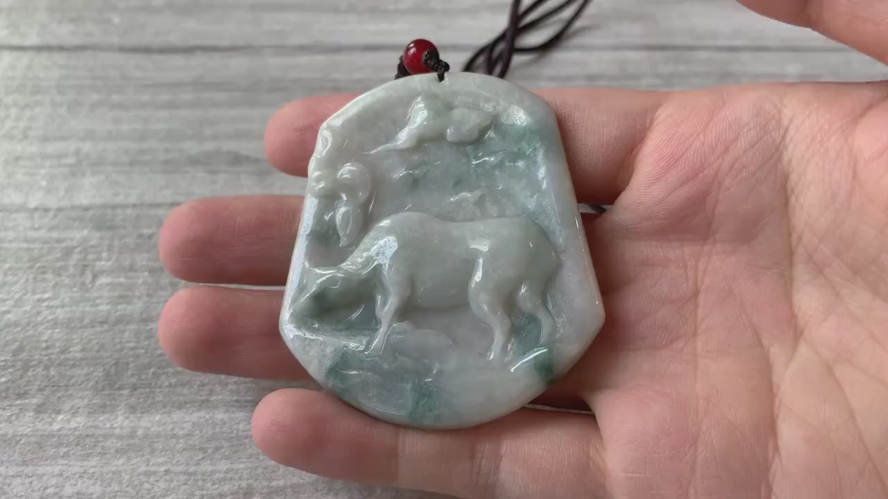 Video of a hand-carved jade ox pendant with detailed muscles, showcasing a green symbolic zodiac design
