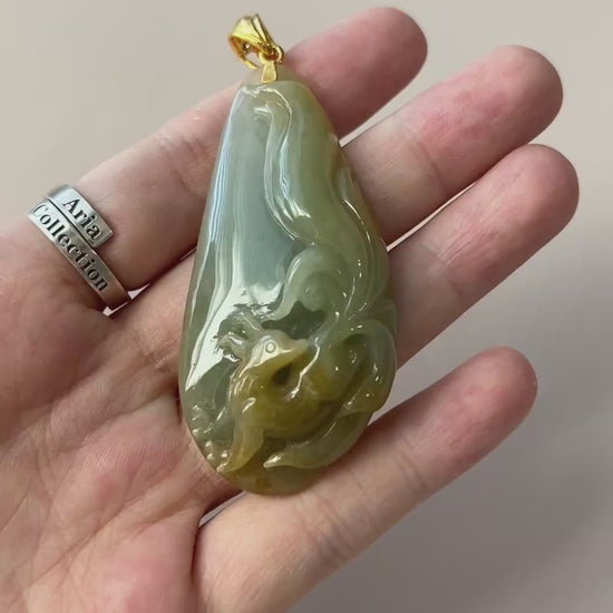 Video of a glossy light green jadeite teardrop pendant with raised fox carving and gold-tone bail