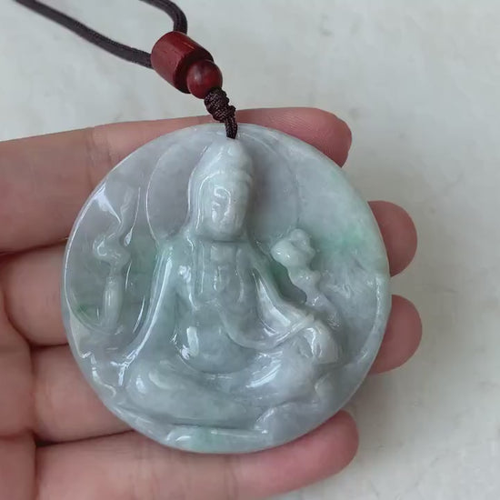 Video of a hand-carved green jade Guan Yin pendant with intricate details and elegant timeless style