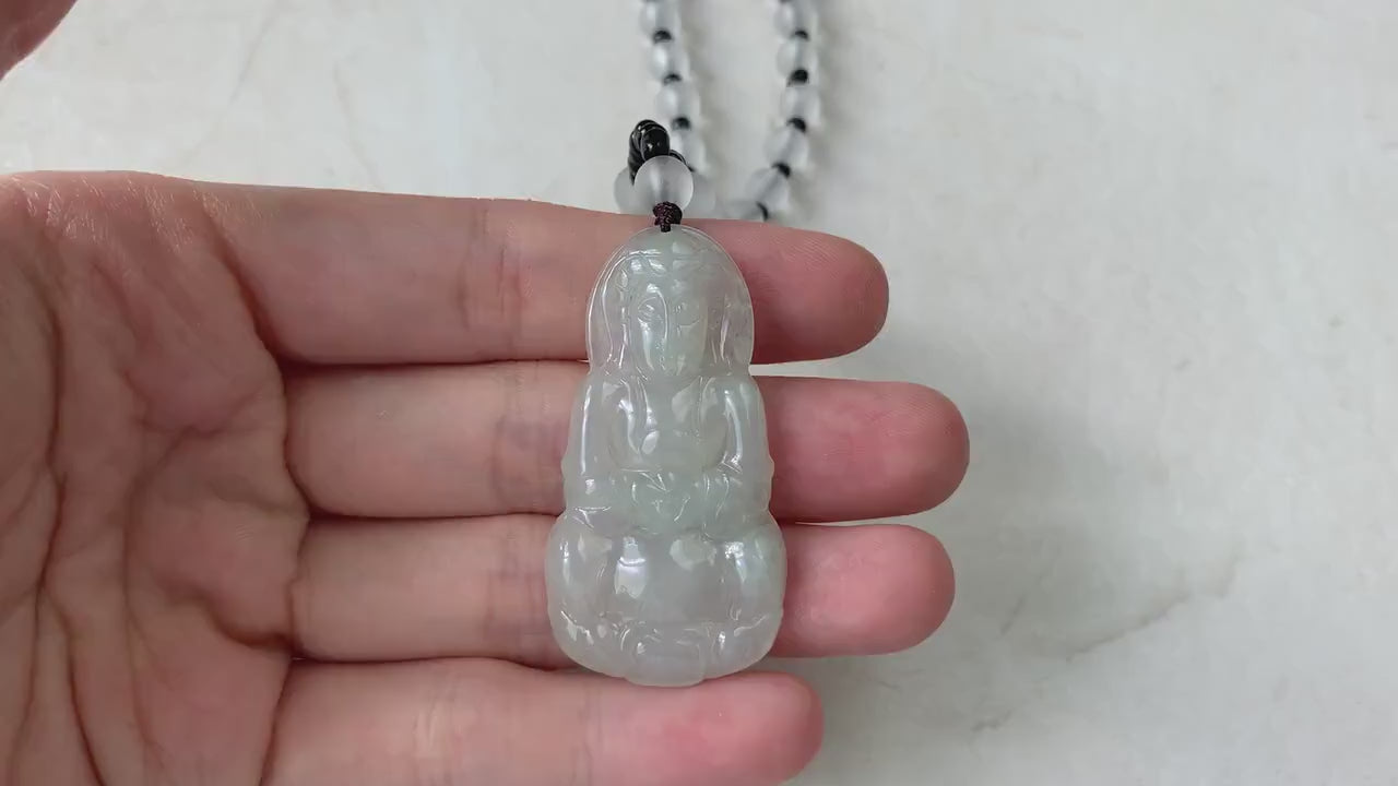 Video of a hand-carved natural jade Guan Yin pendant with intricate detailing and a beaded necklace, elegant green style
