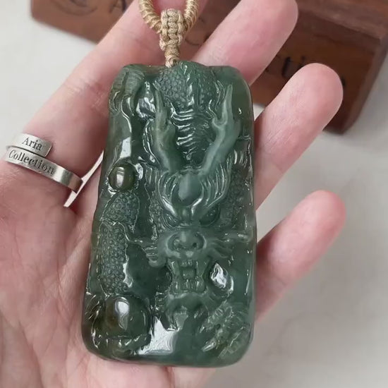 Video of a hand-carved green jadeite Guardian Dragon pendant with vivid hues, intricate carving, and bold sculptural style