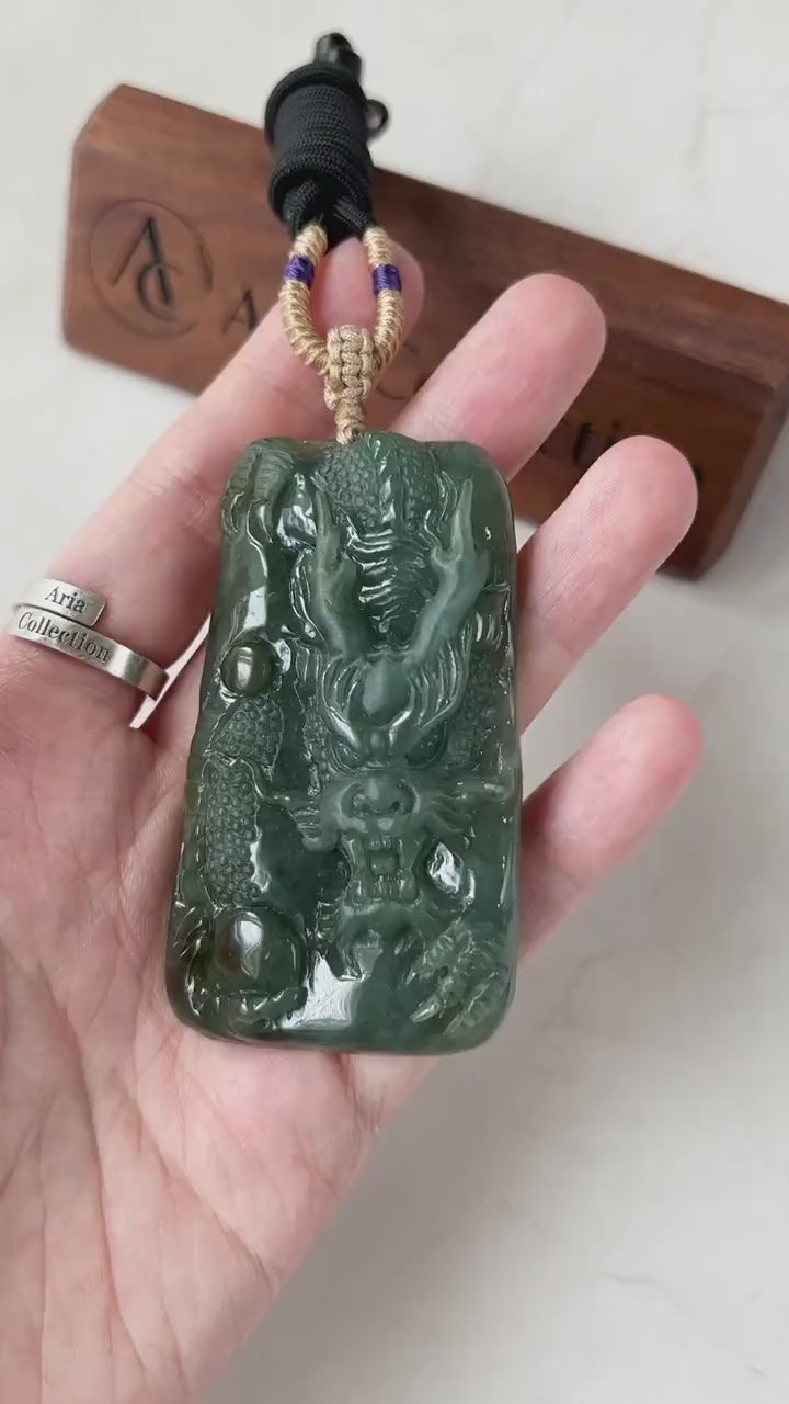 Video of a hand-carved green jadeite Guardian Dragon pendant with vivid hues, intricate carving, and bold sculptural style
