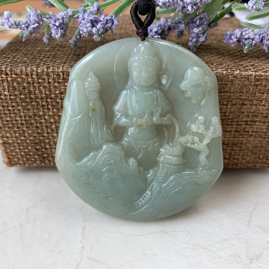 Hand-carved pale green jade Guan Yin mountain landscape pendant, glossy translucent finish, front view on cord