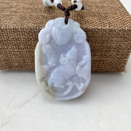 Front view of translucent pale jadeite jade rat pendant with carved relief and polished finish on cord necklace