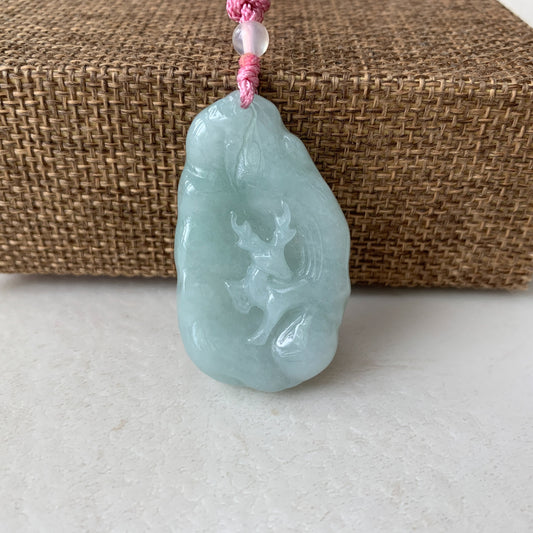 Hand-carved pale green jadeite deer pendant necklace, glossy translucent finish, front view on pink cord