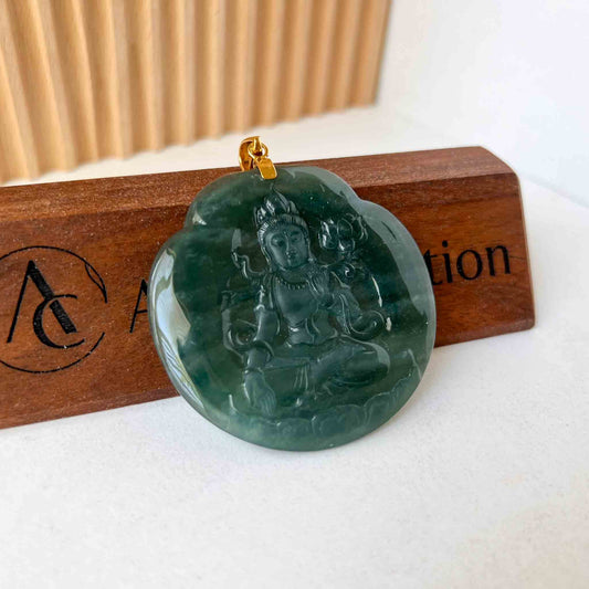 Green jadeite Buddha pendant with 18K gold bail, glossy hand-carved finish, angled on wooden display block