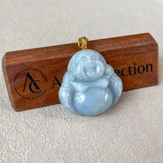 Lavender jade Happy Buddha pendant with glossy carved finish and 18k gold bail, shown on wood display stand